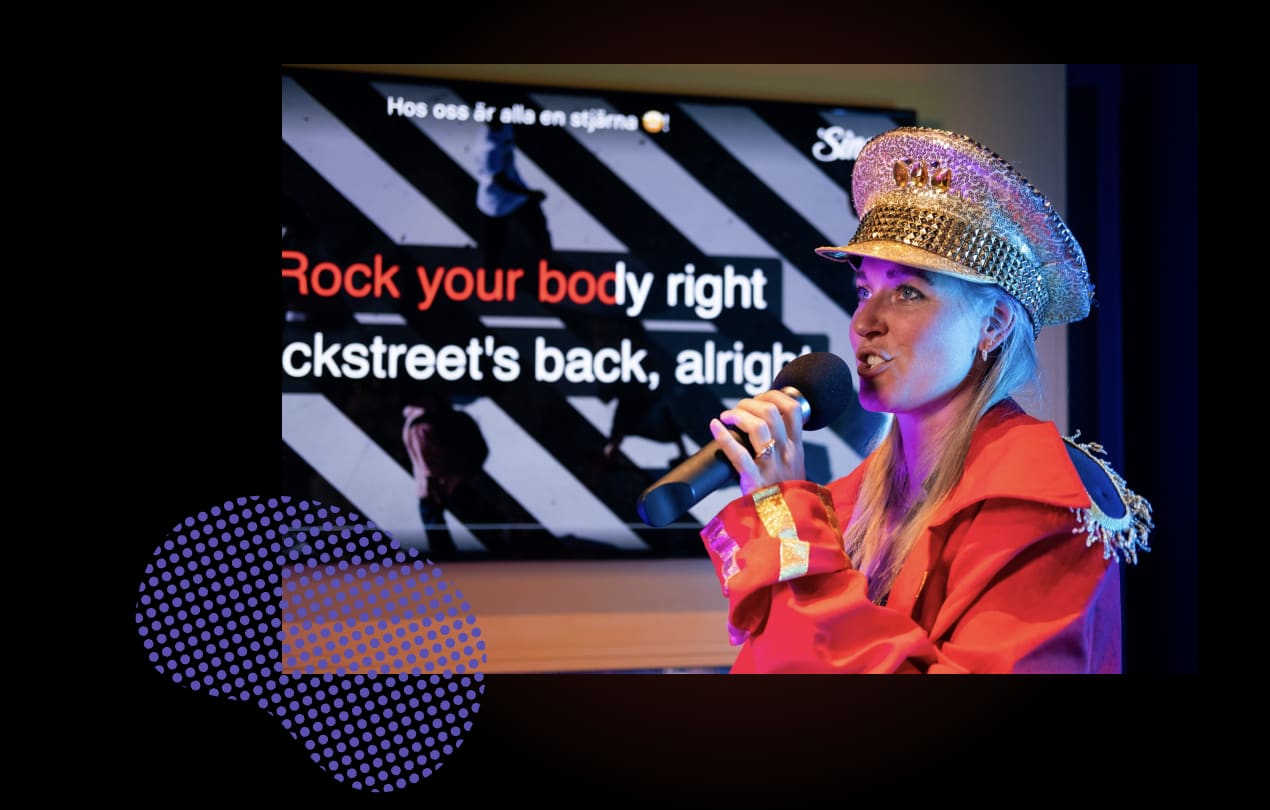 Karaoke performance with backdrop displaying lyrics, performer in colorful attire, modern entertainment experience, social singing apps